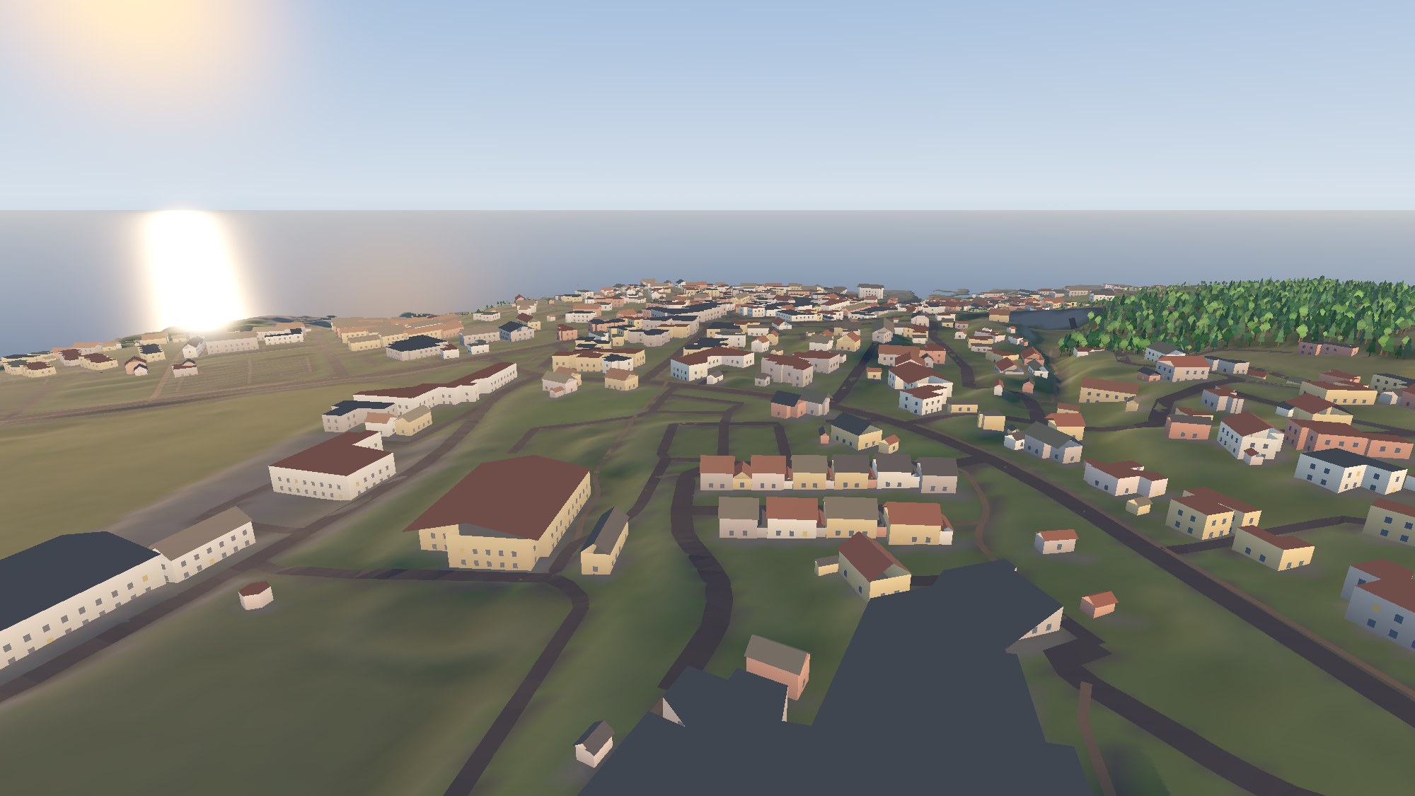 Gudhjem at dusk from the hill above it: hundreds of houses with lit windows, roads winding down to the sea, forest on the ridge.